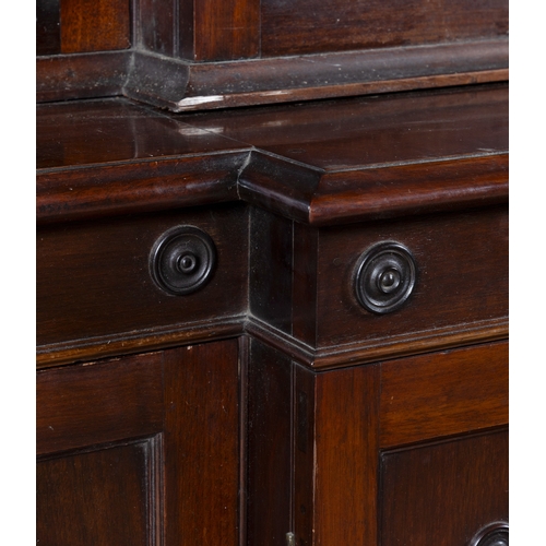 530 - A GEORGE III MAHOGANY FOUR DOOR BREAKFRONT BOOKCASE,  of architectural form with broken swan‑neck pe... 