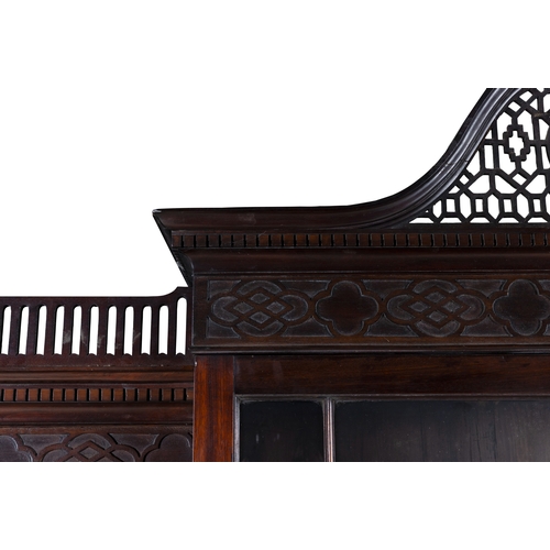 530 - A GEORGE III MAHOGANY FOUR DOOR BREAKFRONT BOOKCASE,  of architectural form with broken swan‑neck pe... 