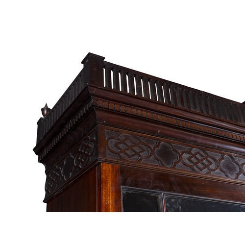 530 - A GEORGE III MAHOGANY FOUR DOOR BREAKFRONT BOOKCASE,  of architectural form with broken swan‑neck pe... 