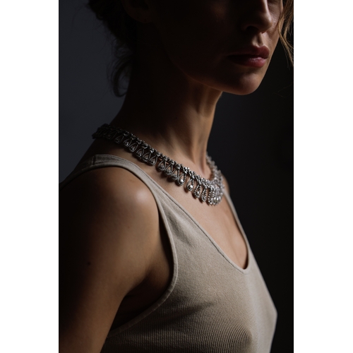 102 - AN IMPORTANT DIAMOND NECKLACE, CIRCA 1960  Of openwork ropetwist design, each loop set with brillian... 