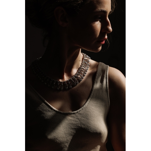 102 - AN IMPORTANT DIAMOND NECKLACE, CIRCA 1960  Of openwork ropetwist design, each loop set with brillian... 