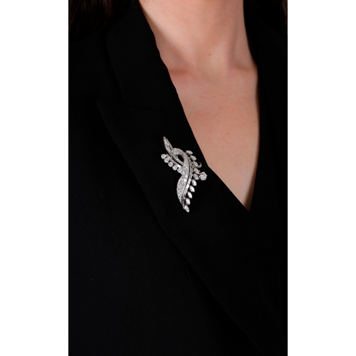 117 - ALBUQUERQUE: A FINE DIAMOND BROOCH, FRENCH, CIRCA 1955  Of sweeping foliate spray design, the centra... 