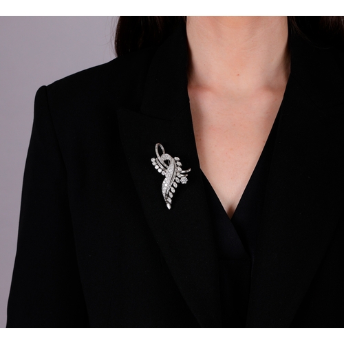 117 - ALBUQUERQUE: A FINE DIAMOND BROOCH, FRENCH, CIRCA 1955  Of sweeping foliate spray design, the centra... 