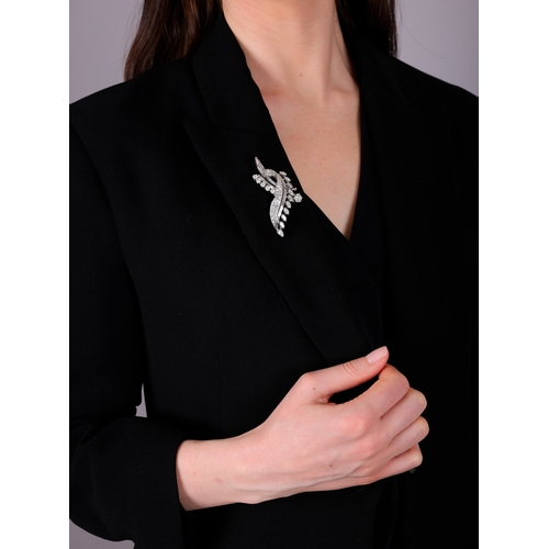 117 - ALBUQUERQUE: A FINE DIAMOND BROOCH, FRENCH, CIRCA 1955  Of sweeping foliate spray design, the centra... 