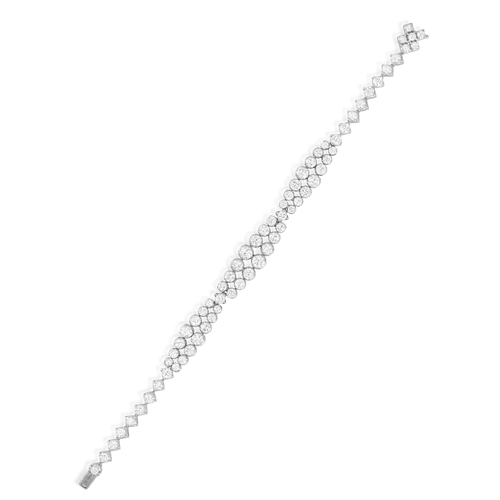 119 - A DIAMOND BRACELET, CIRCA 1965  The flexible strap designed as three double row of graduated brillia... 