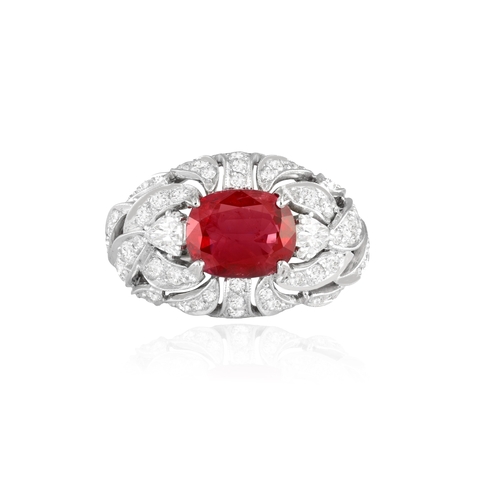 120 - A RUBY AND DIAMOND DRESS RING   Centring a claw-set cushion-shaped ruby weighing approximately 2.60c... 