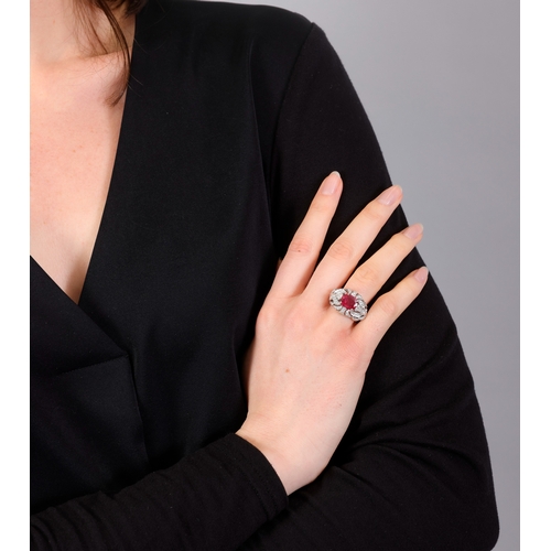 120 - A RUBY AND DIAMOND DRESS RING   Centring a claw-set cushion-shaped ruby weighing approximately 2.60c... 