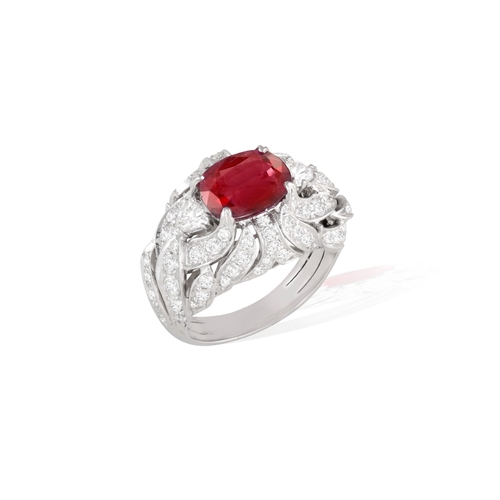 120 - A RUBY AND DIAMOND DRESS RING   Centring a claw-set cushion-shaped ruby weighing approximately 2.60c... 
