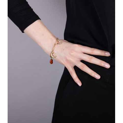 196 - TIFFANY & CO, ELSA PERETTI: A GOLD AND HARDSTONE CHARM BRACELET  The fancy-link chain suspending fou... 
