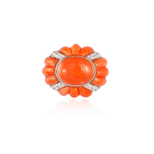 198 - TONY NY: A RETRO CORAL AND DIAMOND RING  The domed bombé mount centring an oval Corallium rubrum cor... 