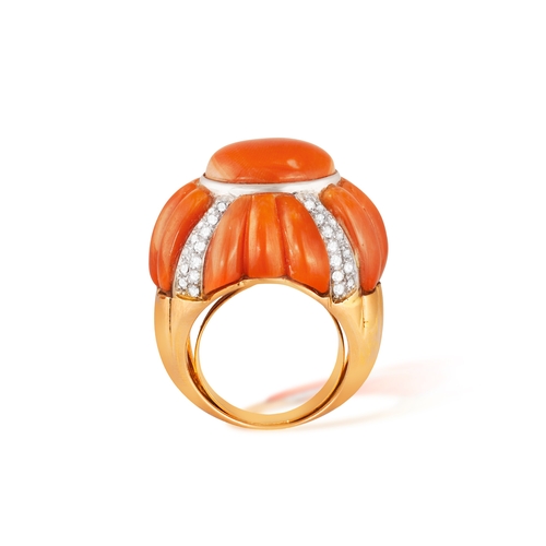 198 - TONY NY: A RETRO CORAL AND DIAMOND RING  The domed bombé mount centring an oval Corallium rubrum cor... 