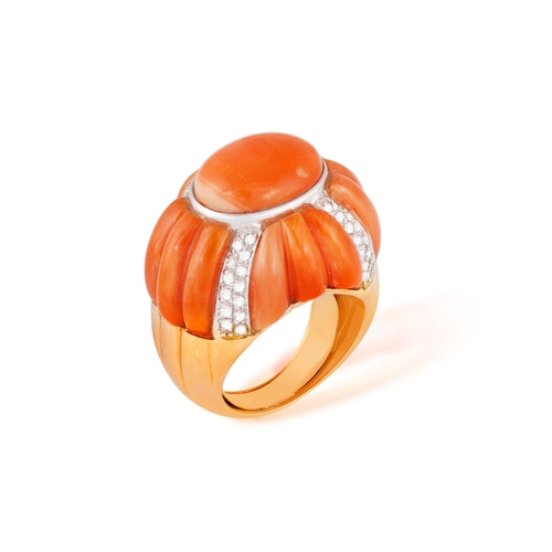 198 - TONY NY: A RETRO CORAL AND DIAMOND RING  The domed bombé mount centring an oval Corallium rubrum cor... 