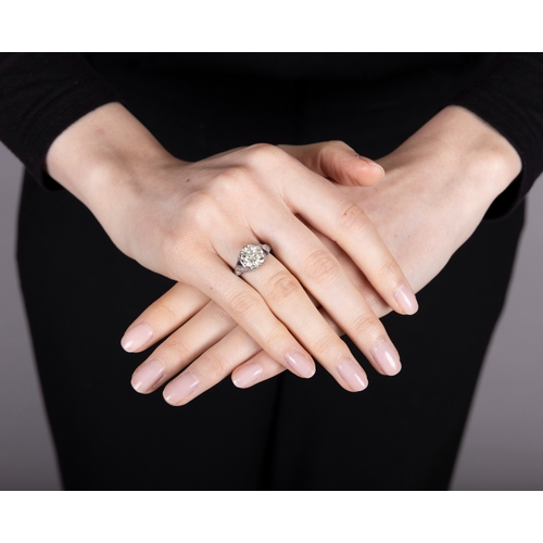 63 - AN ART DECO DIAMOND AND SAPPHIRE RING, CIRCA 1925  Set with an old European-cut diamond weighing app... 