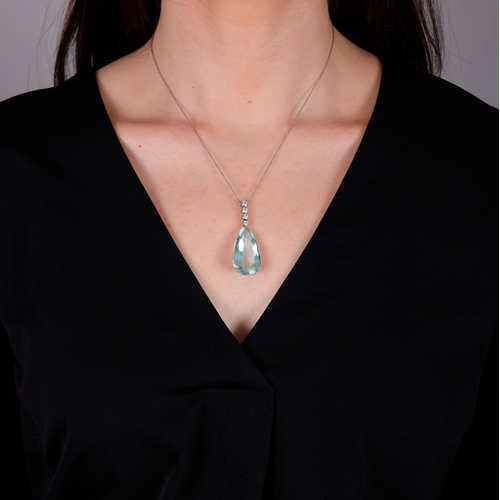 64 - AN AQUAMARINE AND DIAMOND PENDANT NECKLACE  The pear-shaped aquamarine drop weighing approximately 3... 