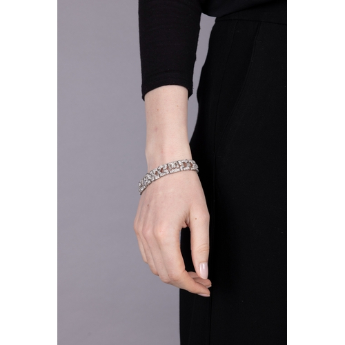65 - AN ART DECO DIAMOND BRACELET, CIRCA 1930  Of openwork geometric design, set throughout with old Euro... 