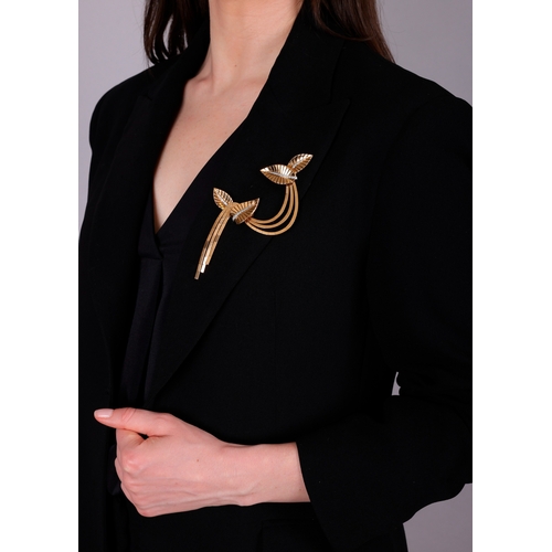 72 - A DIAMOND AND GOLD DOUBLE-CLIP BROOCH, FRENCH, CIRCA 1945-50  Each clip of stylised leaf motif, with... 