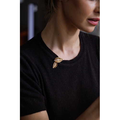 72 - A DIAMOND AND GOLD DOUBLE-CLIP BROOCH, FRENCH, CIRCA 1945-50  Each clip of stylised leaf motif, with... 
