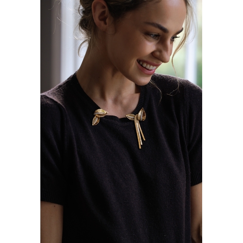 72 - A DIAMOND AND GOLD DOUBLE-CLIP BROOCH, FRENCH, CIRCA 1945-50  Each clip of stylised leaf motif, with... 