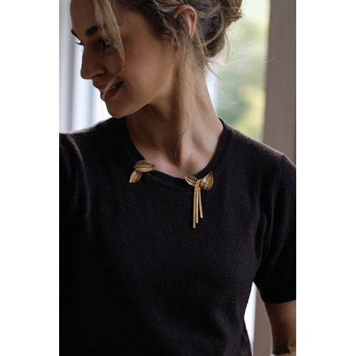 72 - A DIAMOND AND GOLD DOUBLE-CLIP BROOCH, FRENCH, CIRCA 1945-50  Each clip of stylised leaf motif, with... 