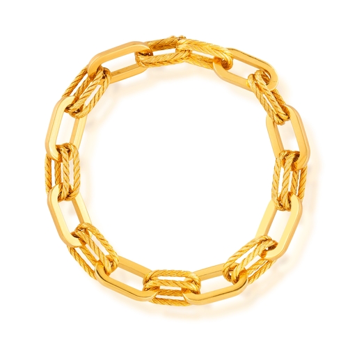 75 - A GOLD BRACELET, CIRCA 1960  Composed of oval polished gold links, interspersed by textured gold rop... 