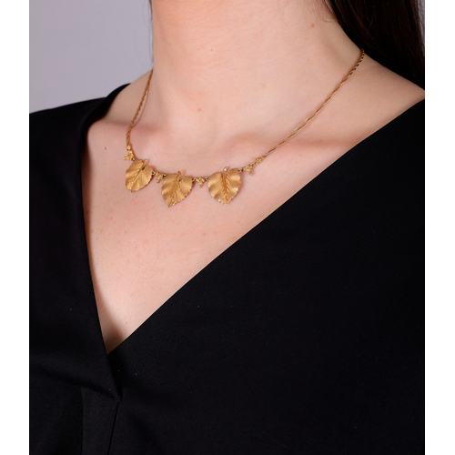 77 - FEDERICO BUCCELLATI: A GOLD NECKLACE  Composed of three textured gold leaves, each with a raised cen... 