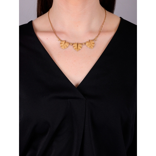 77 - FEDERICO BUCCELLATI: A GOLD NECKLACE  Composed of three textured gold leaves, each with a raised cen... 