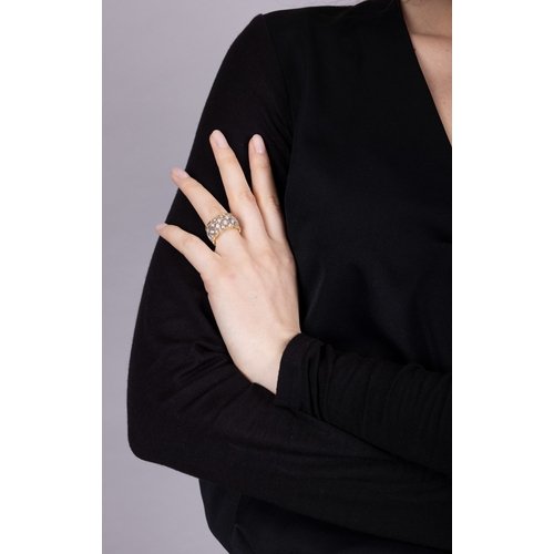 79 - BUCCELLATI: A DIAMOND RING  Of bi-coloured design, formed as a continuous openwork foliate lattice, ... 