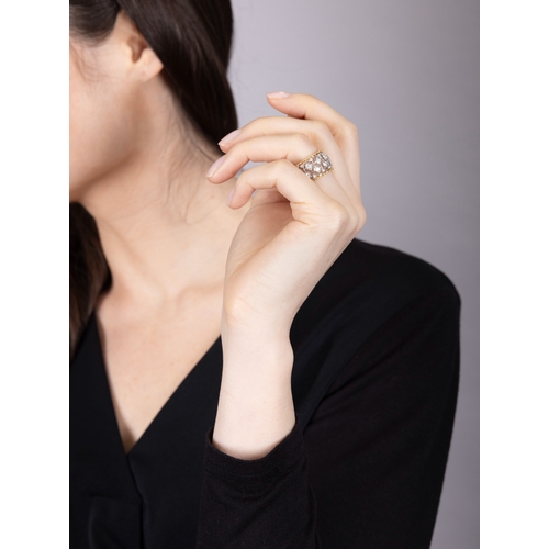 79 - BUCCELLATI: A DIAMOND RING  Of bi-coloured design, formed as a continuous openwork foliate lattice, ... 