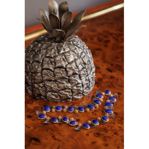 80 - BUCCELLATI: A LAPIS LAZULI NECKLACE, CIRCA 1960  Composed of eighteen slightly graduated oval-shaped... 