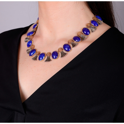 80 - BUCCELLATI: A LAPIS LAZULI NECKLACE, CIRCA 1960  Composed of eighteen slightly graduated oval-shaped... 