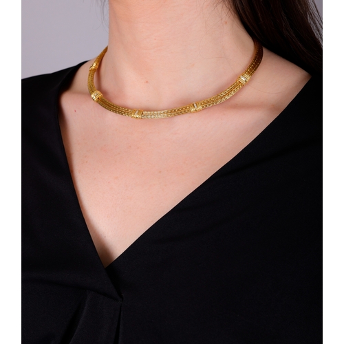 81 - ILIAS LALAOUNIS: A DIAMOND AND GOLD NECKLACE  Composed of a double herringbone rope twist chain, the... 