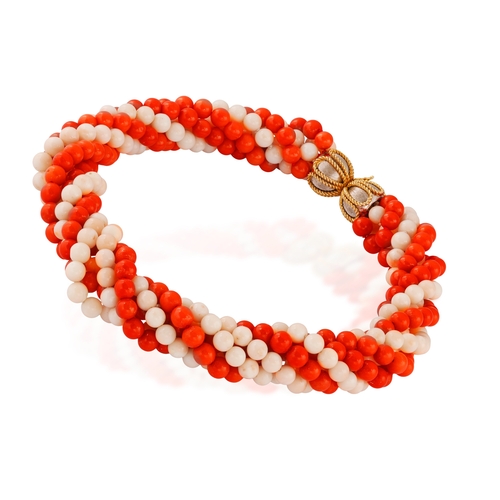 90 - A CORAL AND GOLD NECKLACE, CIRCA 1970  Of torsade design, set with eight strands of red and angel's ... 
