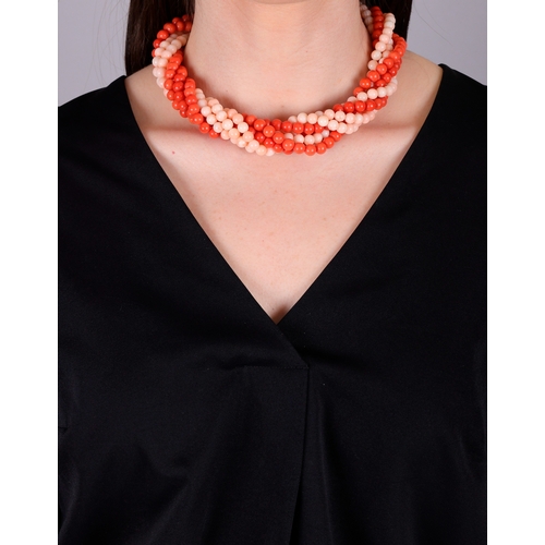 90 - A CORAL AND GOLD NECKLACE, CIRCA 1970  Of torsade design, set with eight strands of red and angel's ... 