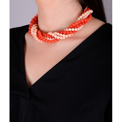 90 - A CORAL AND GOLD NECKLACE, CIRCA 1970  Of torsade design, set with eight strands of red and angel's ... 
