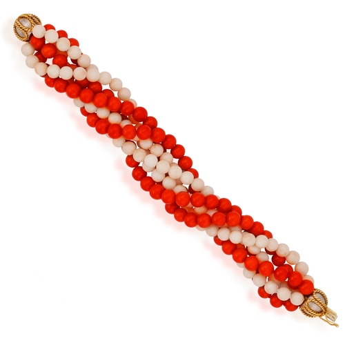 91 - A CORAL AND GOLD BRACELET, CIRCA 1970  Of torsade design, set with six strands of red and angel's sk... 