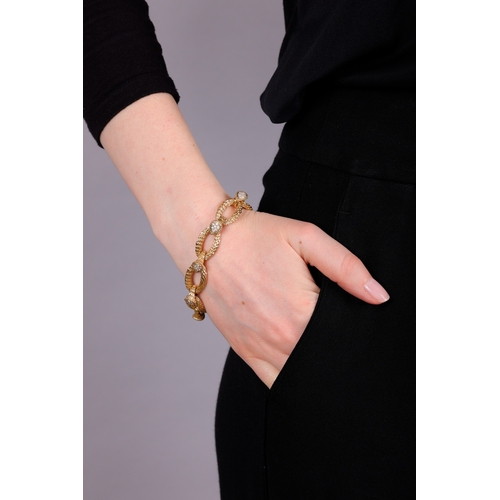 95 - BOUCHERON: A DIAMOND 'SERPENT BOHÈME' BRACELET, CIRCA 1970  Composed of a series of oval-shaped text... 