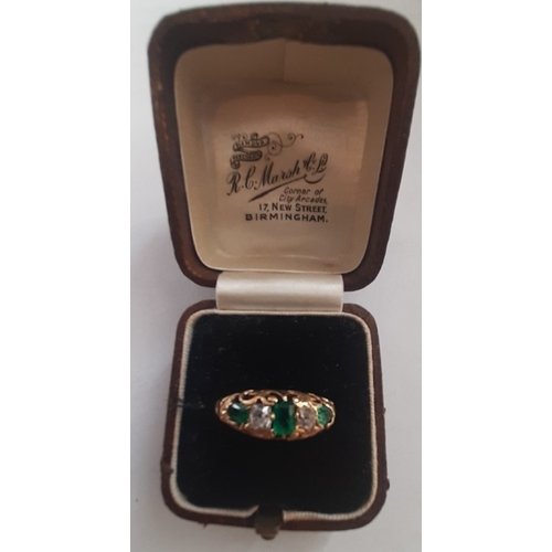 106 - Unmarked yellow metal emerald and diamond ring. Two oval emeralds, 4.00mm x 2.5mm approx. One centre... 