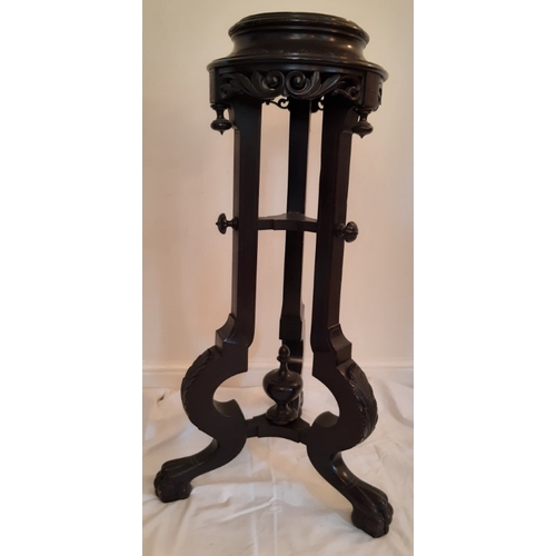 23 - An ebonised jardinière stand with one decorative button missing on upright pillar. 94cm H.