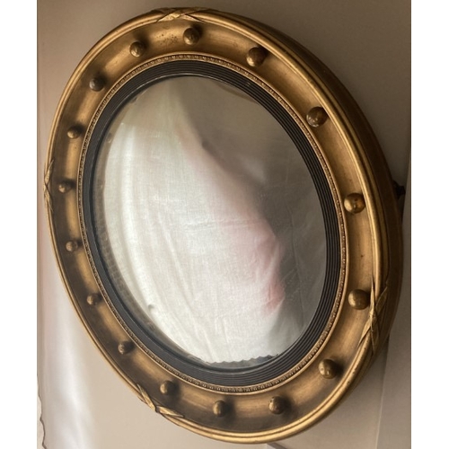 31 - An early 20th Century convex gilt framed mirror, 54cm D approx.