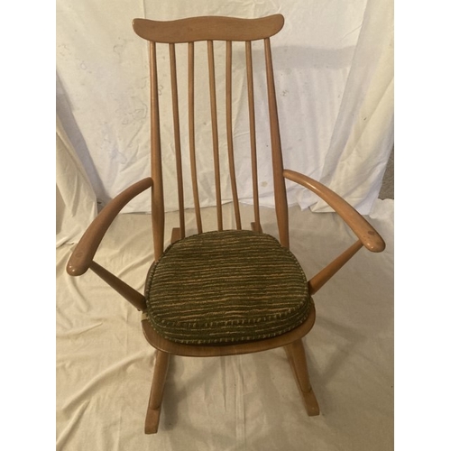 33 - Ercol light oak rocking chair, original cushion in need of new padding.