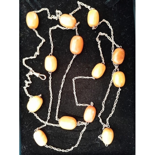 95 - A 137cm yellow metal chain with hook clasp marked 9ct and a number of evenly spaced beads, possibly ... 