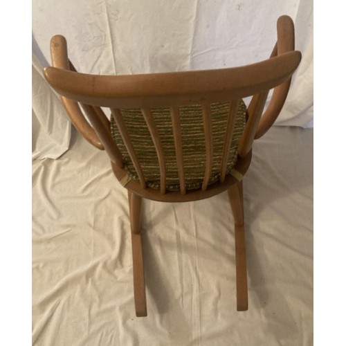 33 - Ercol light oak rocking chair, original cushion in need of new padding.