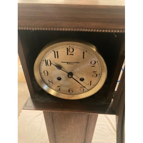 72 - Early to mid 20th century oak cased chiming granddaughter clock, striking on the gong.