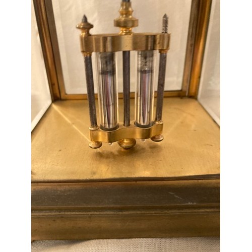 75 - Early brass carriage style mantle clock with mercury pendulum, striking on a bell, bevelled glass pa... 