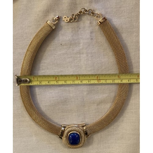 92 - A Christian Dior yellow metal necklace set with a blue stone marked Christian Dior Germany Giusse.