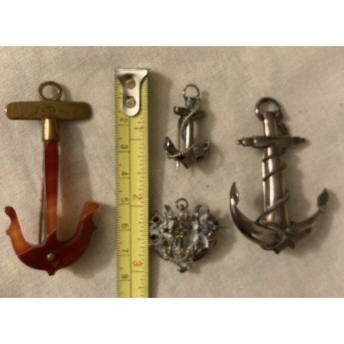 97 - Four various anchor shaped brooches, silver and yellow metal.