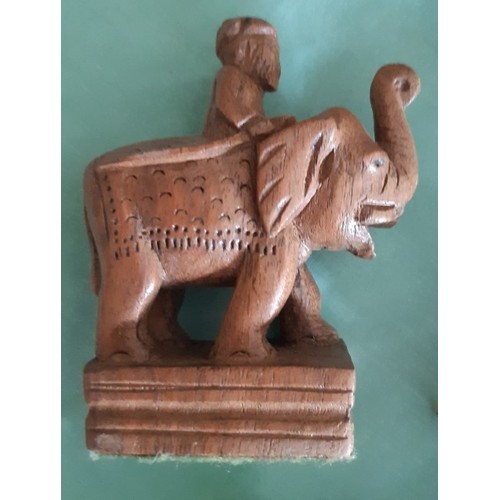 119 - An intricately carved wooden Asian elephant themed chess set