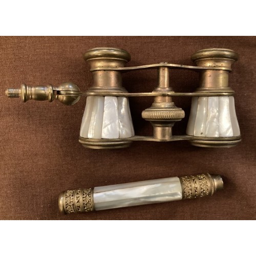 122 - An early pair of yellow metal and mother of pearl opera glasses with detachable hand piece