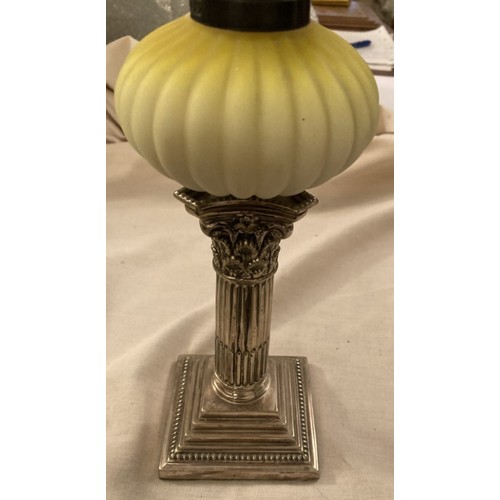 130 - An early peg lamp with green milk glass shade, height including chimney 47cm