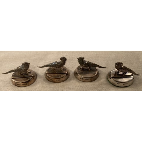 148 - A boxed set of four HM silver menu holders depicting pheasants